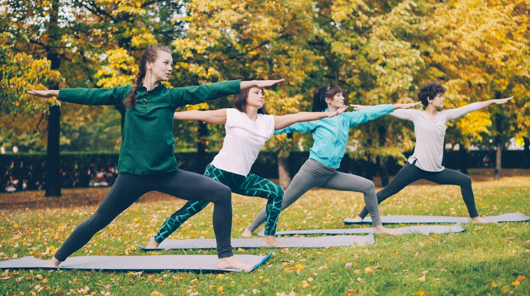 Group practising yoga outdoors
